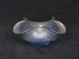 a glass bowl that is sitting on a black surface