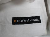 a white shirt with a black and orange label on it