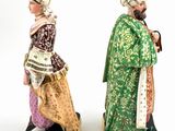 two figurines of men dressed in oriental clothing and hats