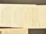 several papers are sitting on a table next to a pair of scissors