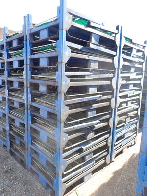 a lot of trays that are stacked up on a rack