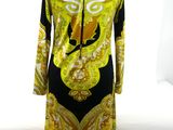 a dress on a mannequin stand in front of a window