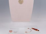 gold plated necklace and earring set on display on a mannequin
