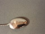a silver spoon with a rope on it on a table