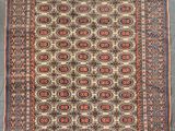 an antique persian rug with geometric design and fringe fringes