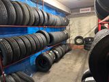 many tires stacked on the shelves in the garage