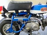 a blue and white motorcycle parked on a blue carpet