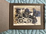 an old photo of a man and a woman sitting in a carriage