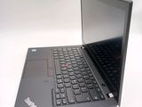 a laptop that is open on a white surface