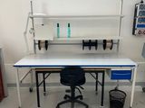 an image of a lab room with a desk and chairs