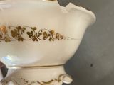 a white bowl with a gold design on it