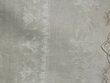 a white table cloth with a decorative design on it