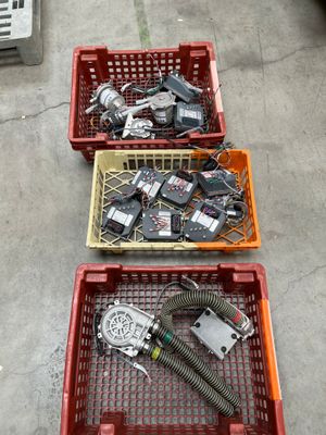 three baskets of assorted electronic devices on the ground