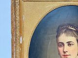 portrait of a woman in a blue dress with a gold frame
