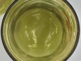 two glasses with green liquid in them on a table