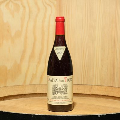 a bottle of wine sitting on top of a barrel