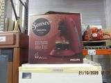 a box of coffee sitting on top of a refrigerator in a store