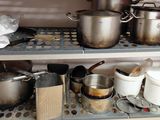 many pots and pans on the shelves in the kitchen