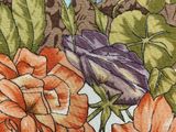 a close up of a floral design on a table cloth