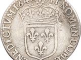 a silver coin with a crown on top of it