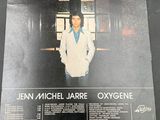 the album cover of jean michel jarre oxygene is displayed on a table