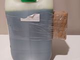 a plastic container with a plastic lid and a green cap