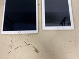 two ipads sitting side by side on a table