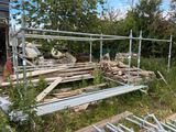 a pile of wood sitting in a yard next to a fence