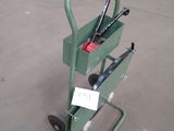 a small green cart with a pair of skis on top of it