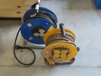 two reels that are sitting on the floor