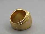 an image of a gold ring sitting on top of a table