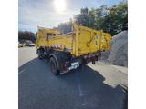 a yellow dump truck that is parked in the parking lot
