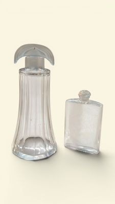 a glass bottle with a soap dispenser next to a glass bottle with a soap dispenser
