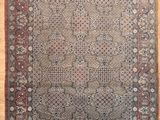 an antique persian rug on a wooden floor