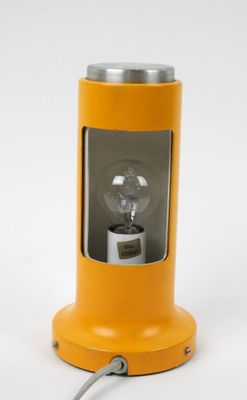 an orange lamp with a light bulb sitting on top of it