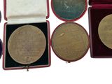 several different types of medals in a red case on a white surface