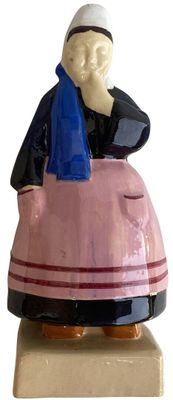 a figurine of a man sitting on top of a pink car