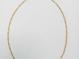 a gold necklace with a twisted link on a white background