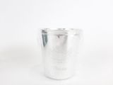a close up of a silver cup on a white surface