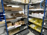 a room with a lot of shelves and bins in it