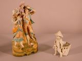 two figurines that are sitting next to each other