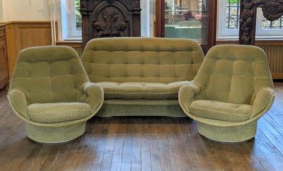 trois fauteuils et un canapé dans un salon