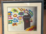tableau représentant la tête d'une femme aux cheveux colorés, posé sur un chevalet