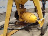 a yellow machine that is sitting on the side of the road