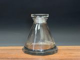 a small glass vase on a wooden table