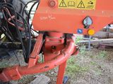 a red machine that is sitting in the dirt