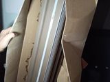 a person that is holding a box with a laptop inside of it