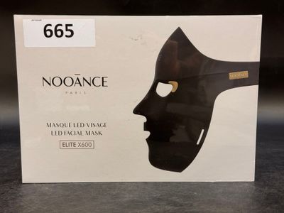 the box of a black mask is sitting on a table