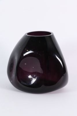 a purple vase that is sitting on a white surface