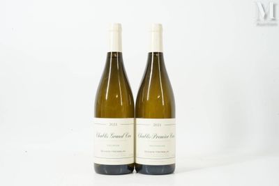 two bottles of white wine sitting next to each other on a white surface